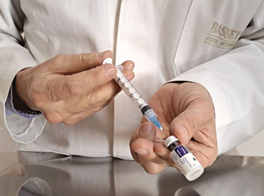 A clinician preparing an injection in a clinical treatment room